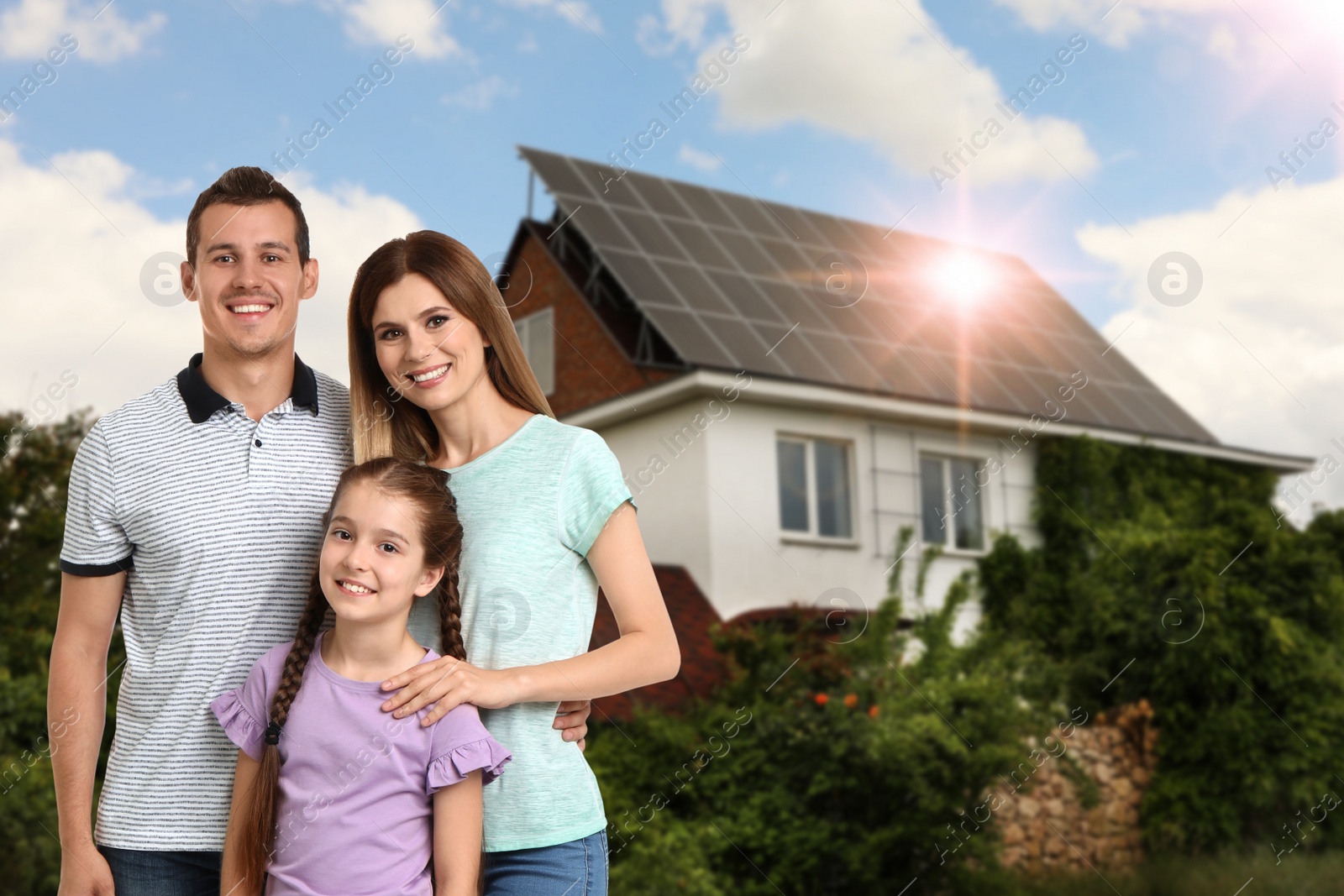 Image of Happy family near their house with solar panels. Alternative energy source