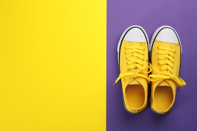 Photo of Stylish sneakers on color background, flat lay. Space for text