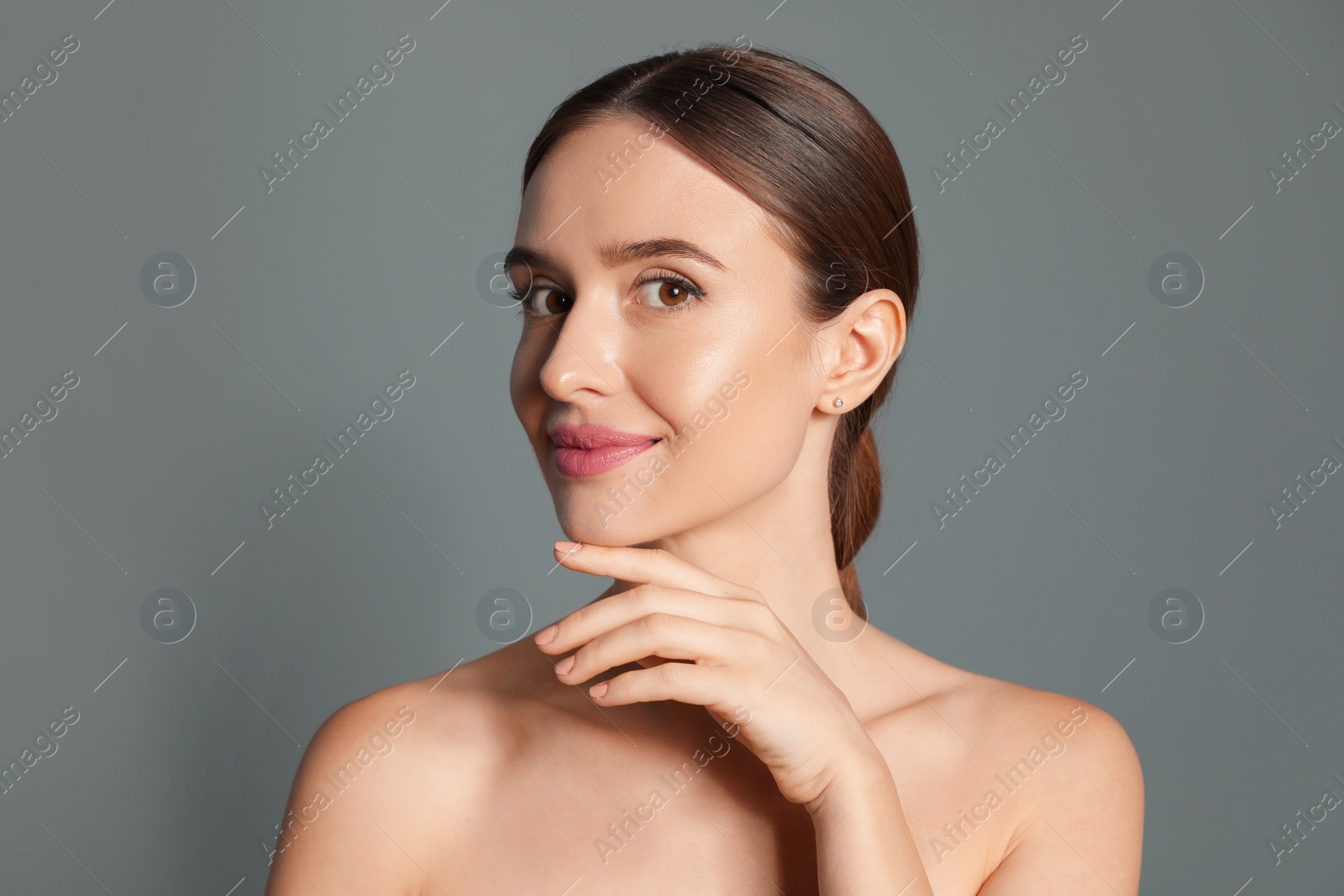 Photo of Beautiful woman with perfect smooth skin on grey background