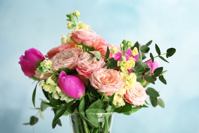 Vase with bouquet of beautiful fragrant flowers on color background