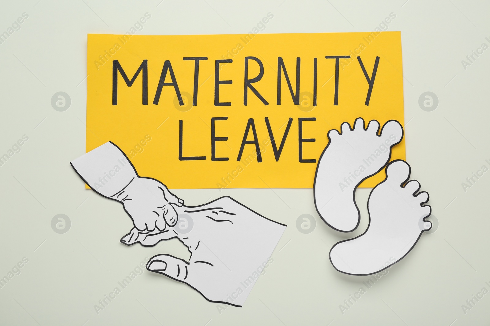 Photo of Note with words Maternity Leave and different paper cutouts on white background, top view