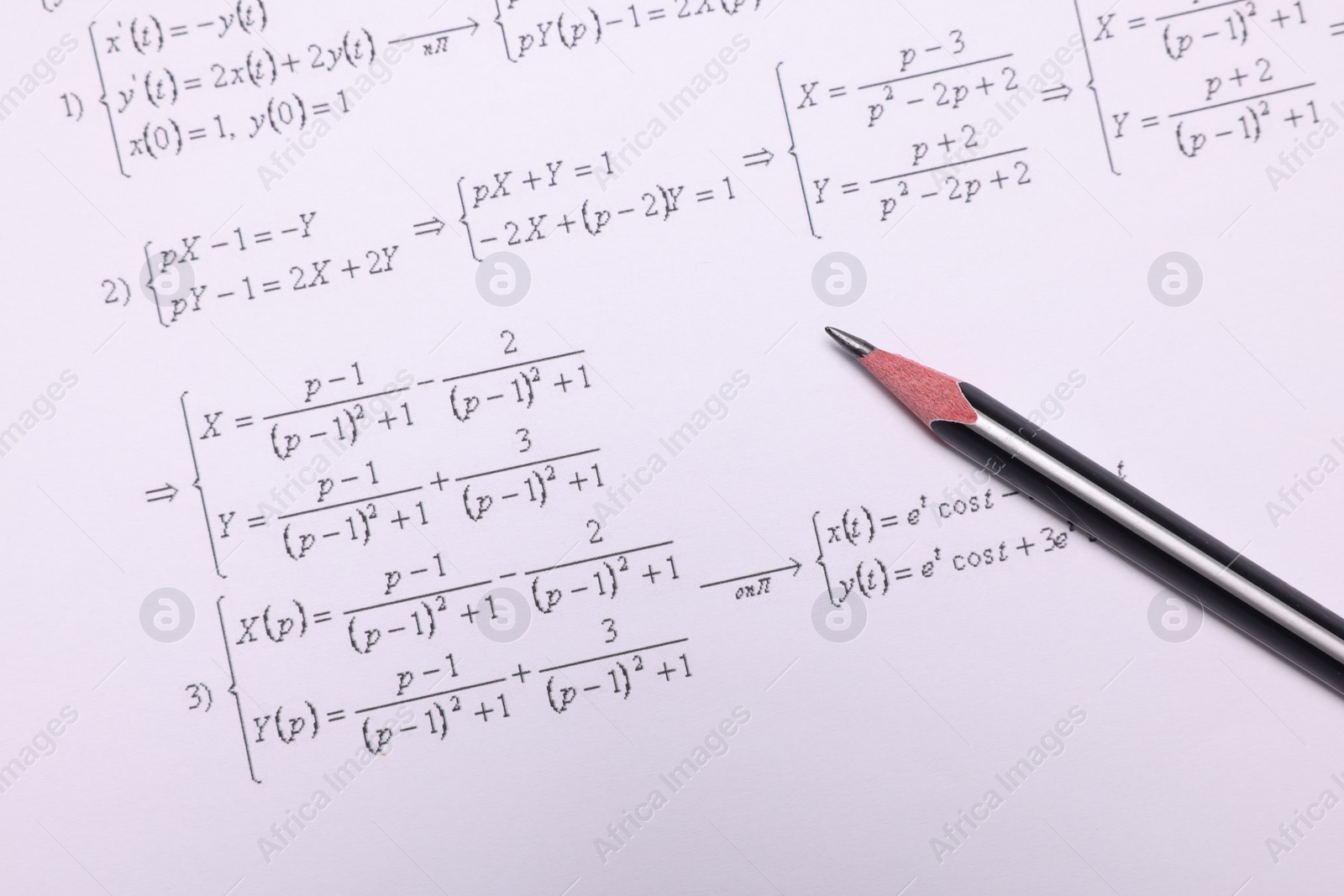 Photo of Sheet of paper with mathematical formulas and pencil, top view