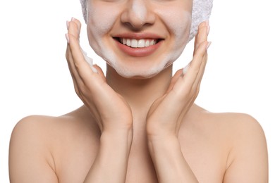 Young woman washing face with cleansing foam on white background, closeup. Skin care cosmetic