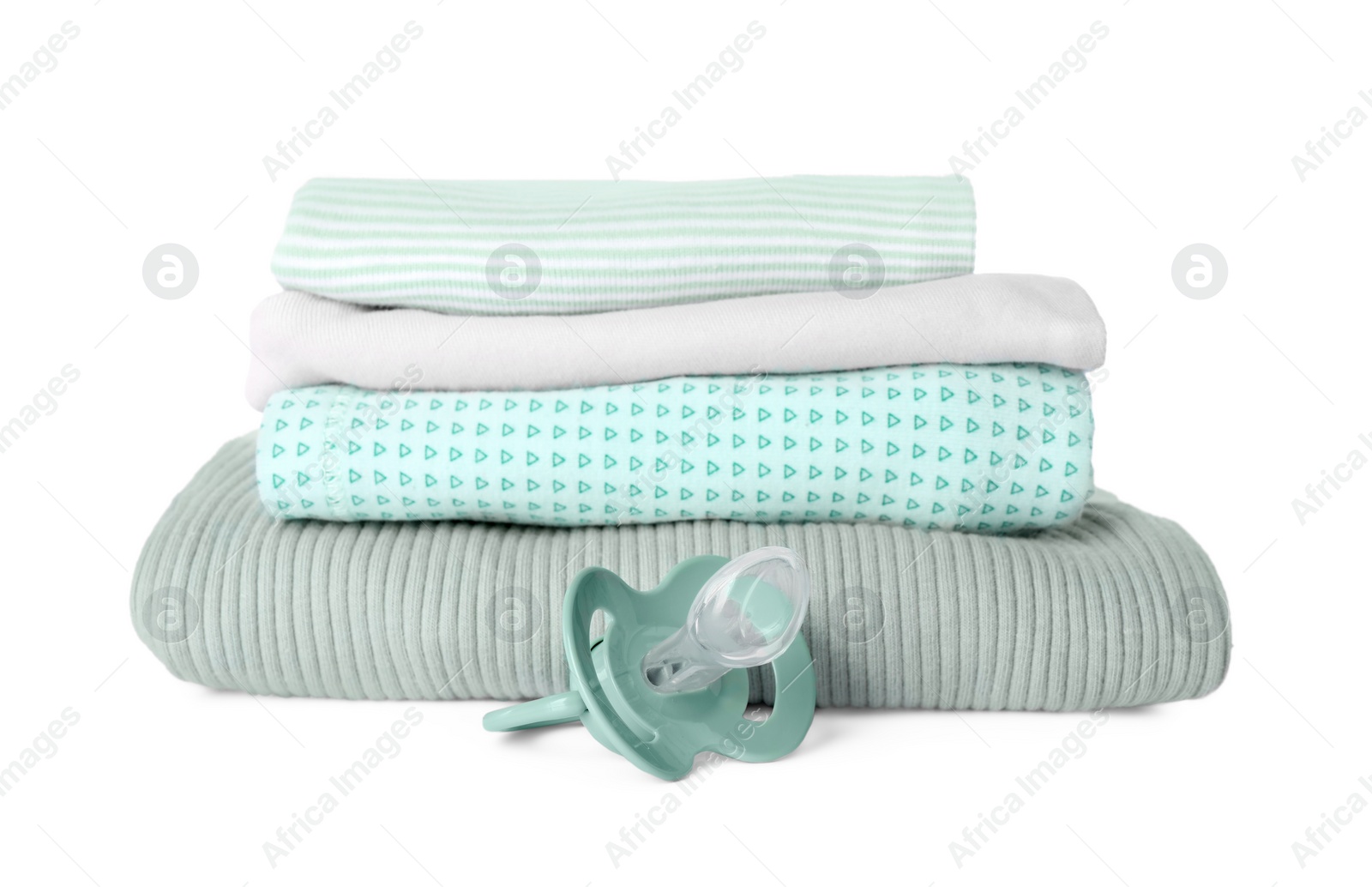 Photo of Stacked clothes and baby pacifier isolated on white