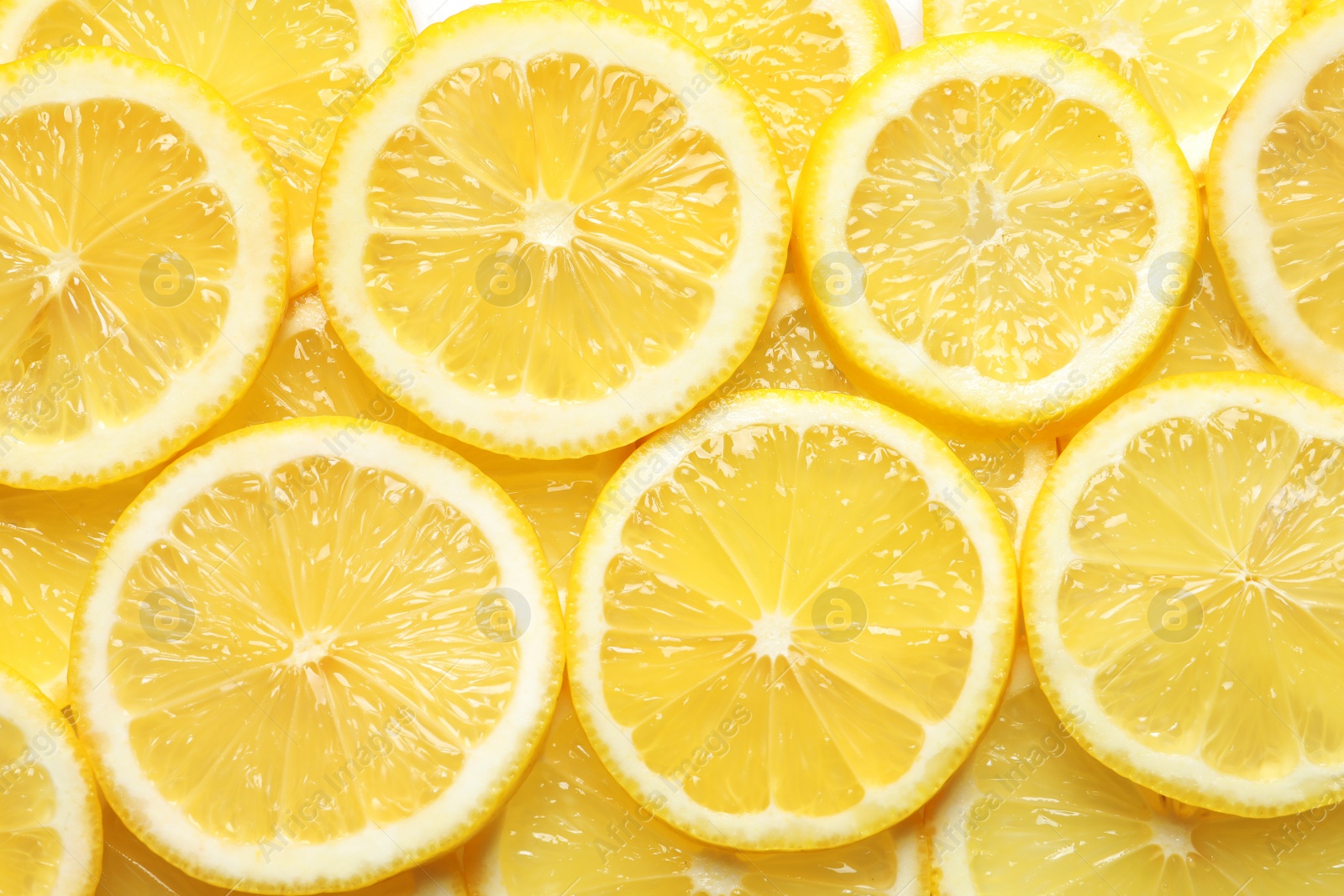 Photo of Juicy lemon slices as background, top view. Citrus fruit