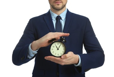 Photo of Businessman holding alarm clock on white background, closeup. Time management