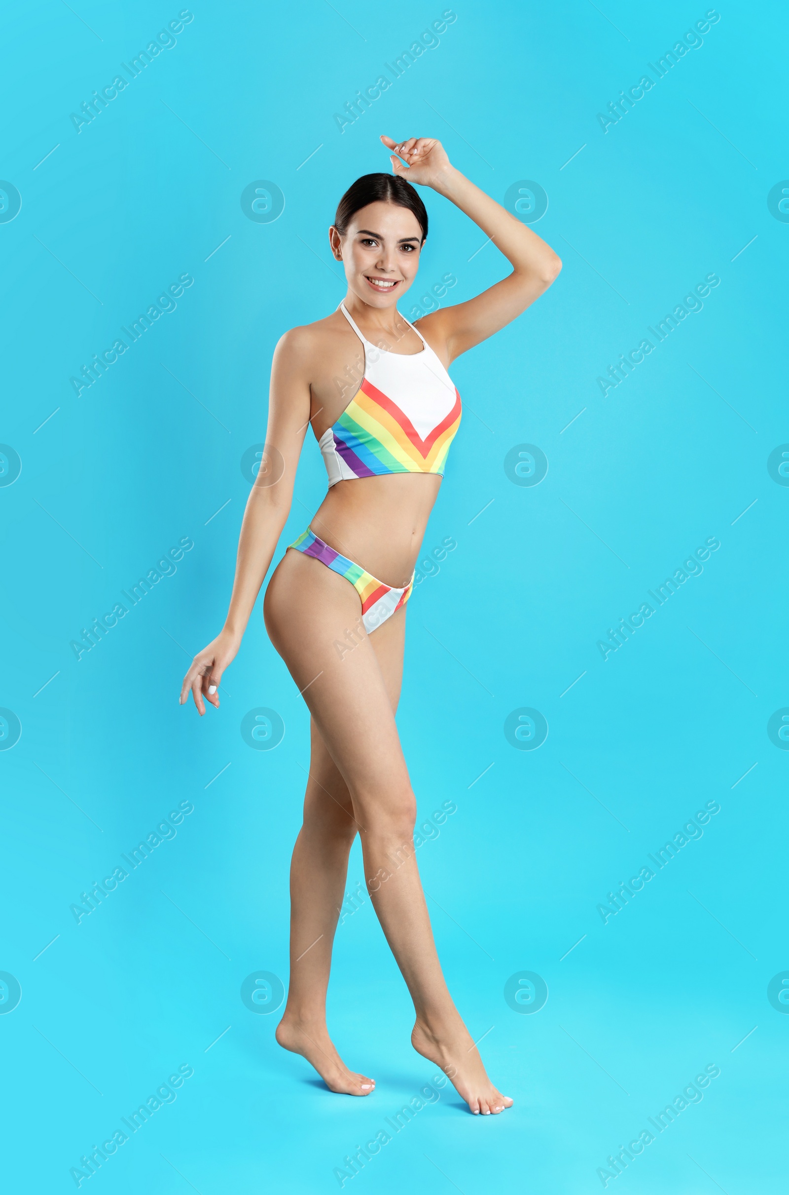 Photo of Full length portrait of attractive young woman with slim body in swimwear on color background