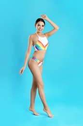 Photo of Full length portrait of attractive young woman with slim body in swimwear on color background