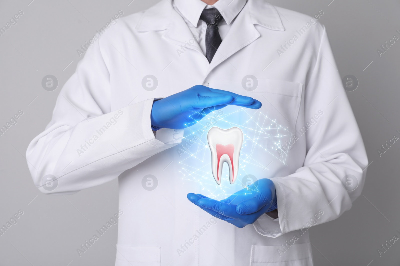 Image of Dentist showing virtual model of tooth on light grey background, closeup