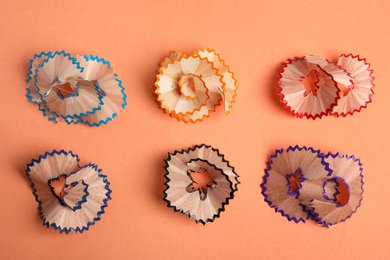 Photo of Pencil shavings on orange background, top view