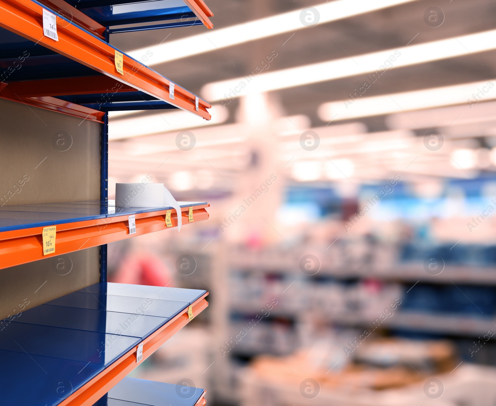 Image of Almost empty shelves in supermarket, closeup. Product deficiency due to social panic 