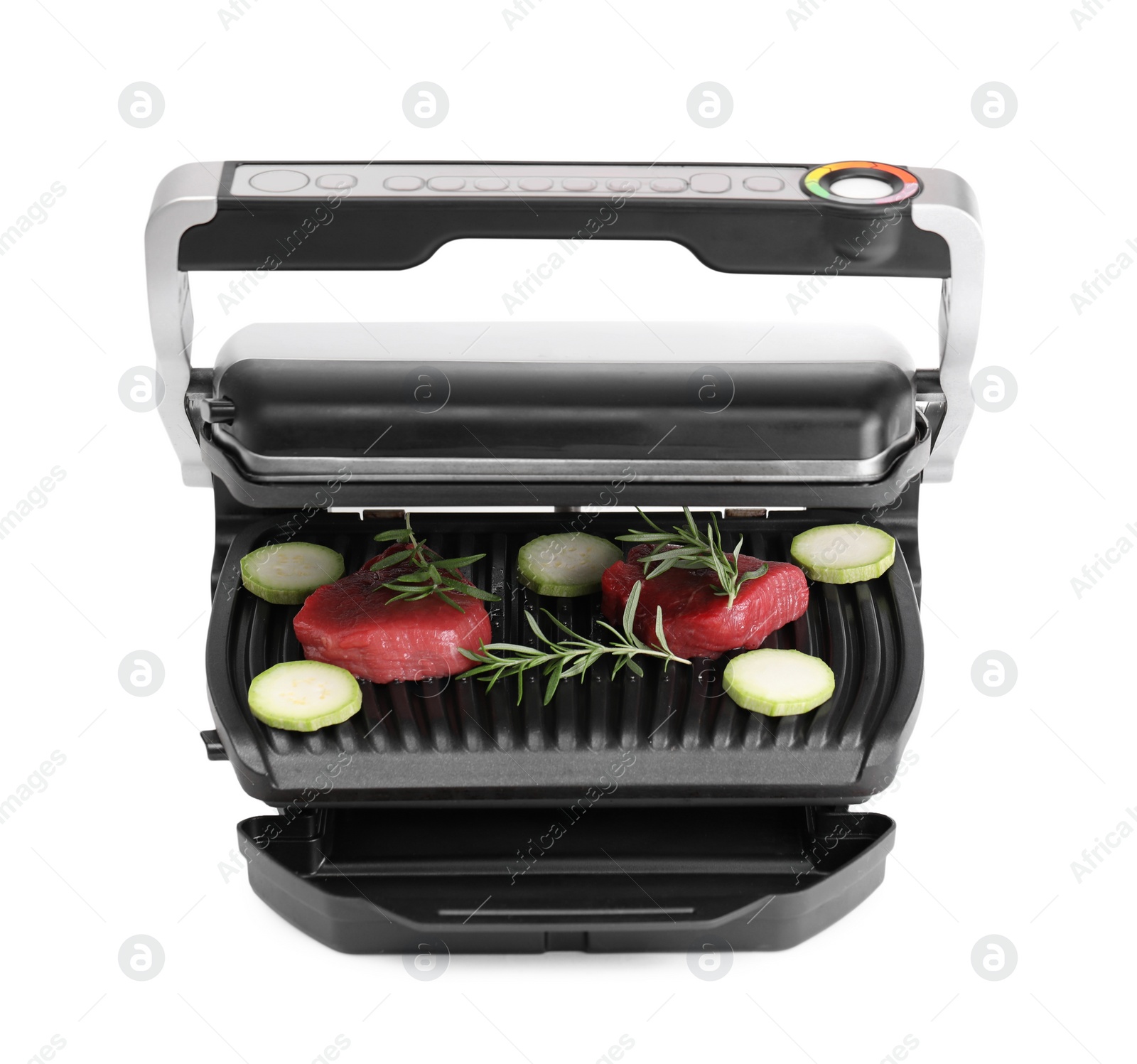 Photo of Electric grill with raw meat, zucchini and rosemary isolated on white, top view