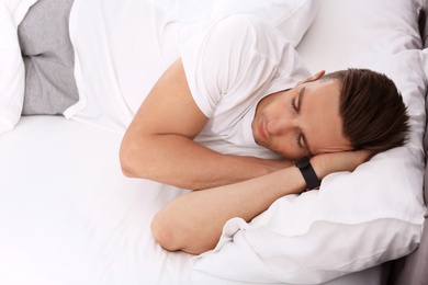 Photo of Young man sleeping in bed at home