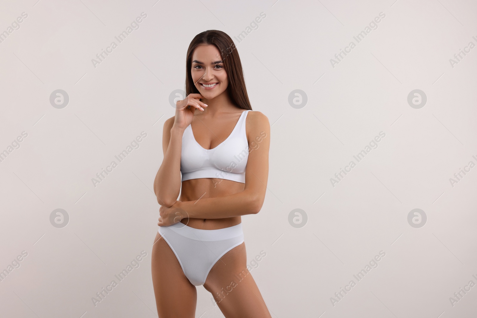 Photo of Young woman in stylish bikini on white background. Space for text