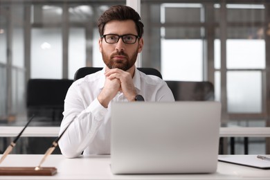 Portrait of serious man in office. Lawyer, businessman, accountant or manager