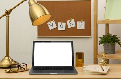 Photo of Stylish workplace with different golden accessories indoors. Idea for interior design