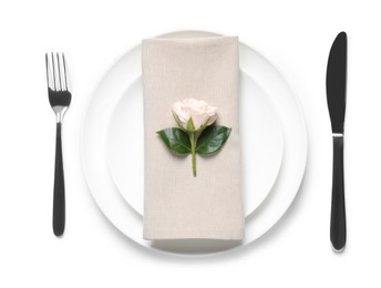 Beautiful table setting with rose on white background, flat lay