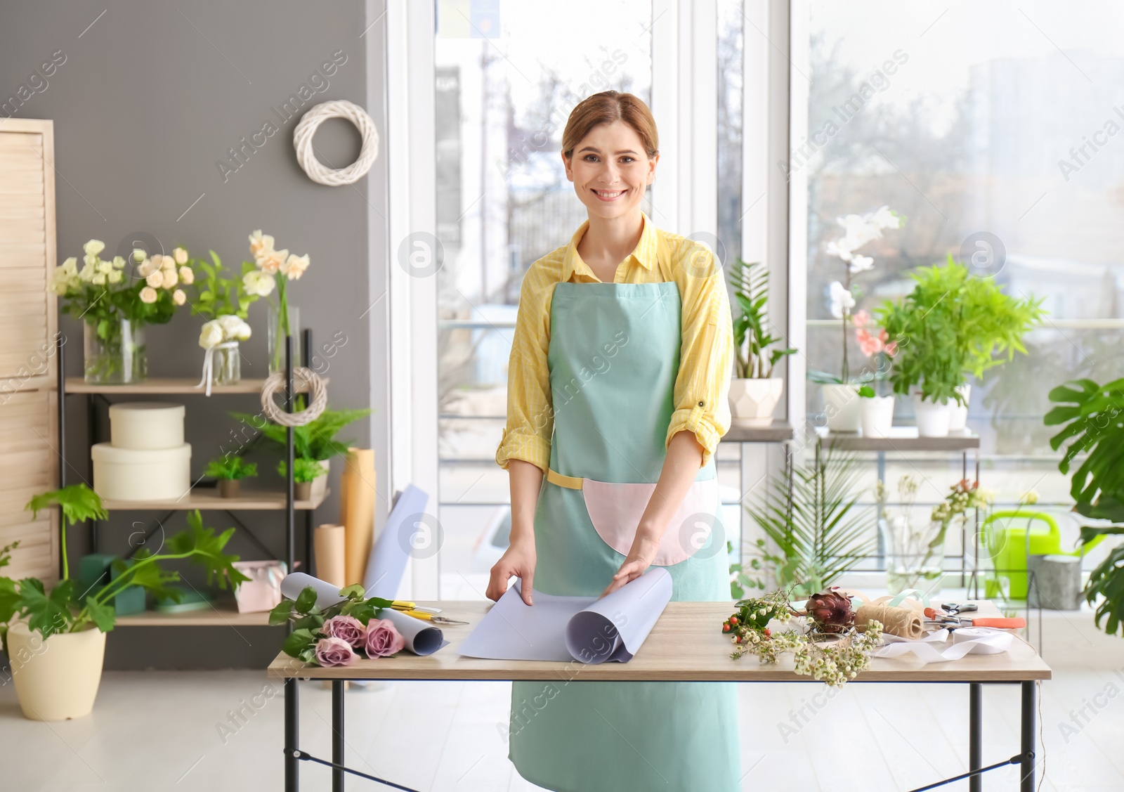 Photo of Female florist creating bouquet at workplace