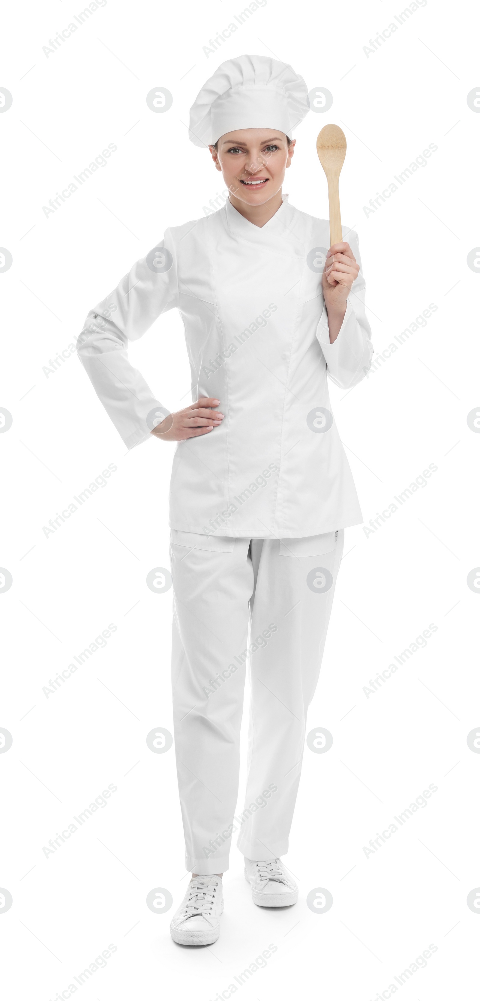 Photo of Happy chef in uniform holding wooden spoon on white background