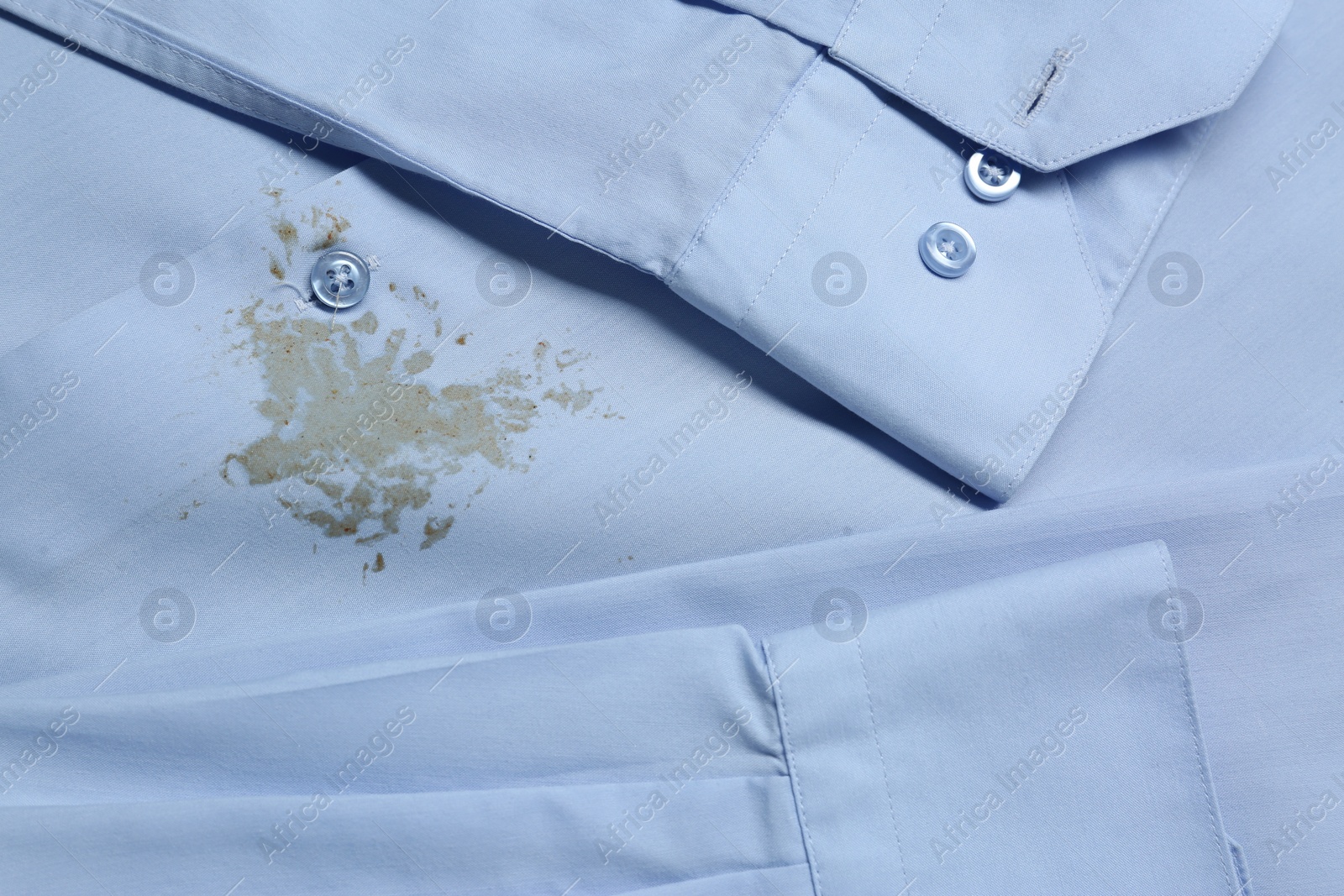 Photo of Closeup view of light blue shirt with stain
