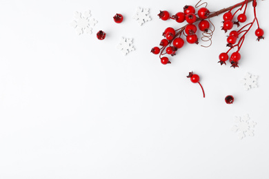 Winter composition with decorative branches on white background, top view