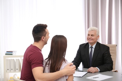 Lawyer having meeting with young couple in office