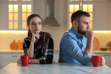 Photo of Young couple quarreling at home. Jealousy in relationship