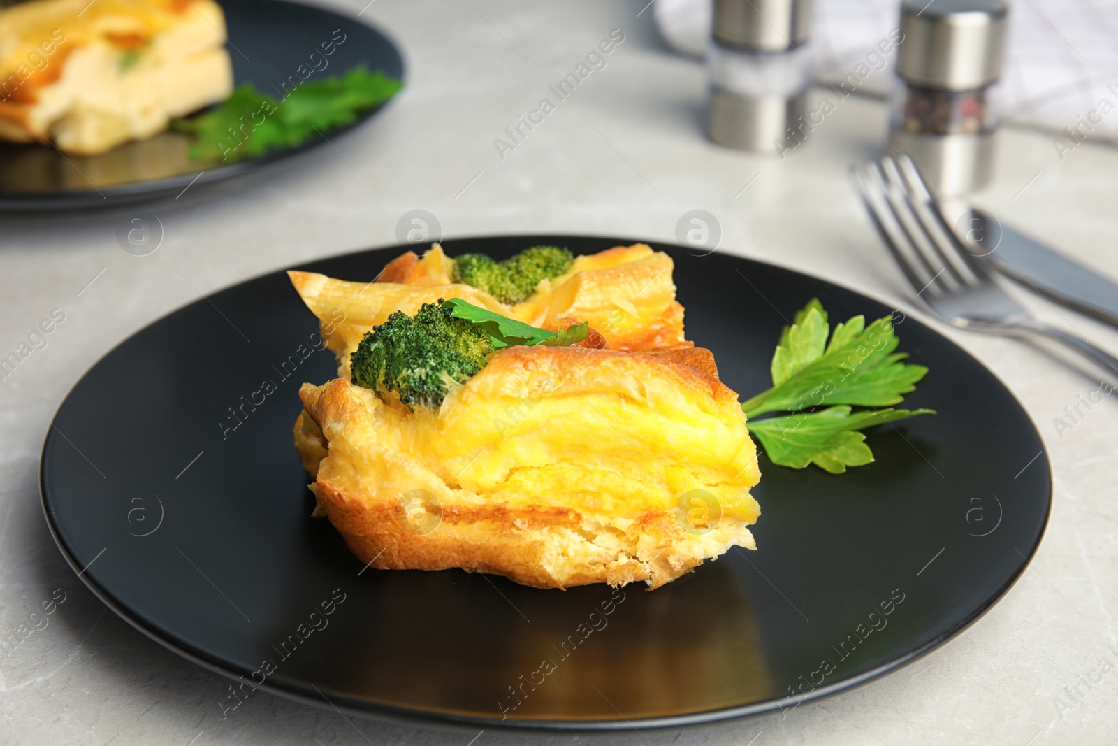 Photo of Tasty broccoli casserole served on grey table