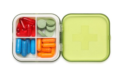 Photo of Different pills in organizer isolated on white, top view