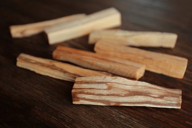 Palo santo sticks on wooden table, closeup