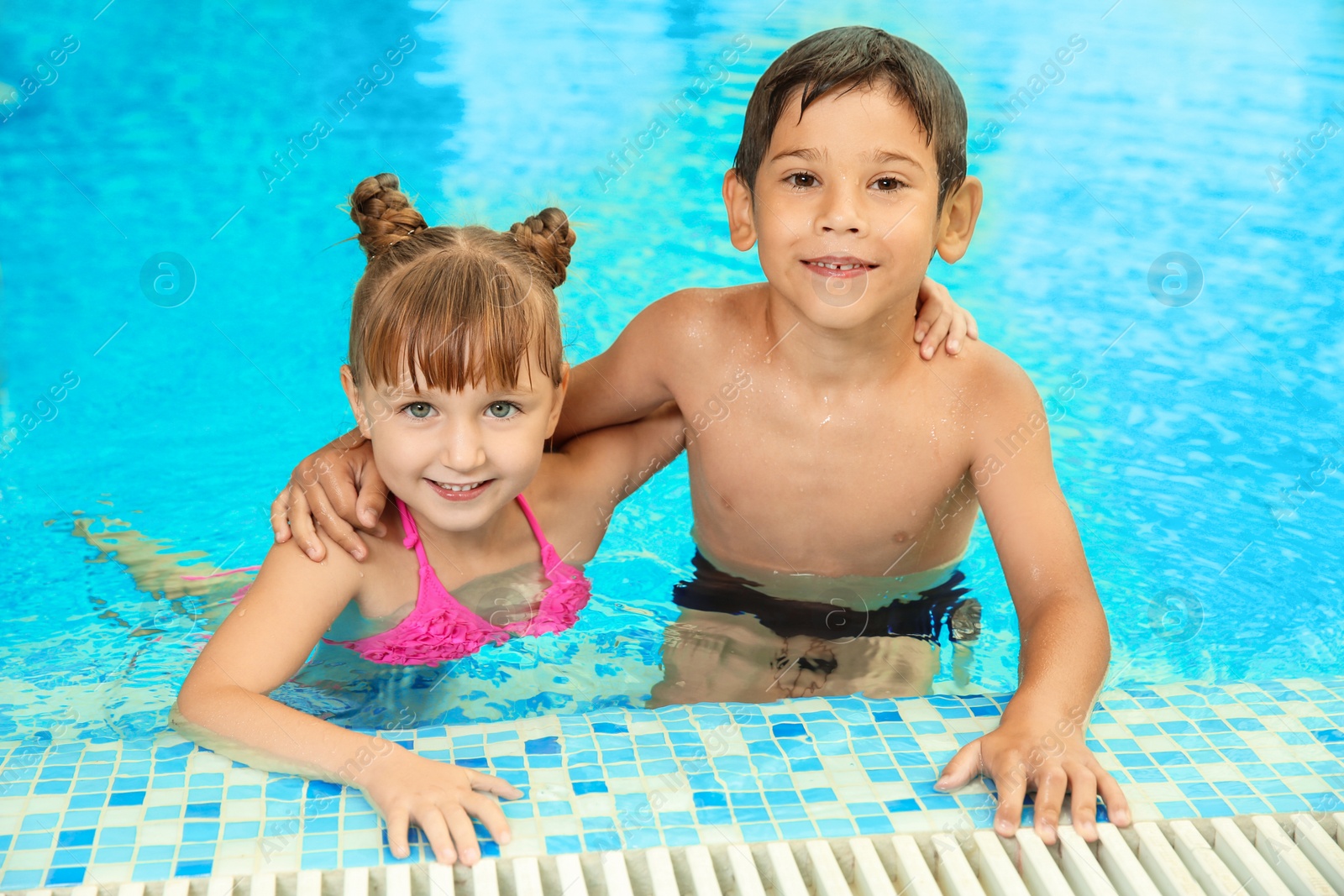 Photo of Happy children resting together in swimming pool