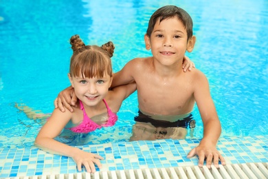 Happy children resting together in swimming pool