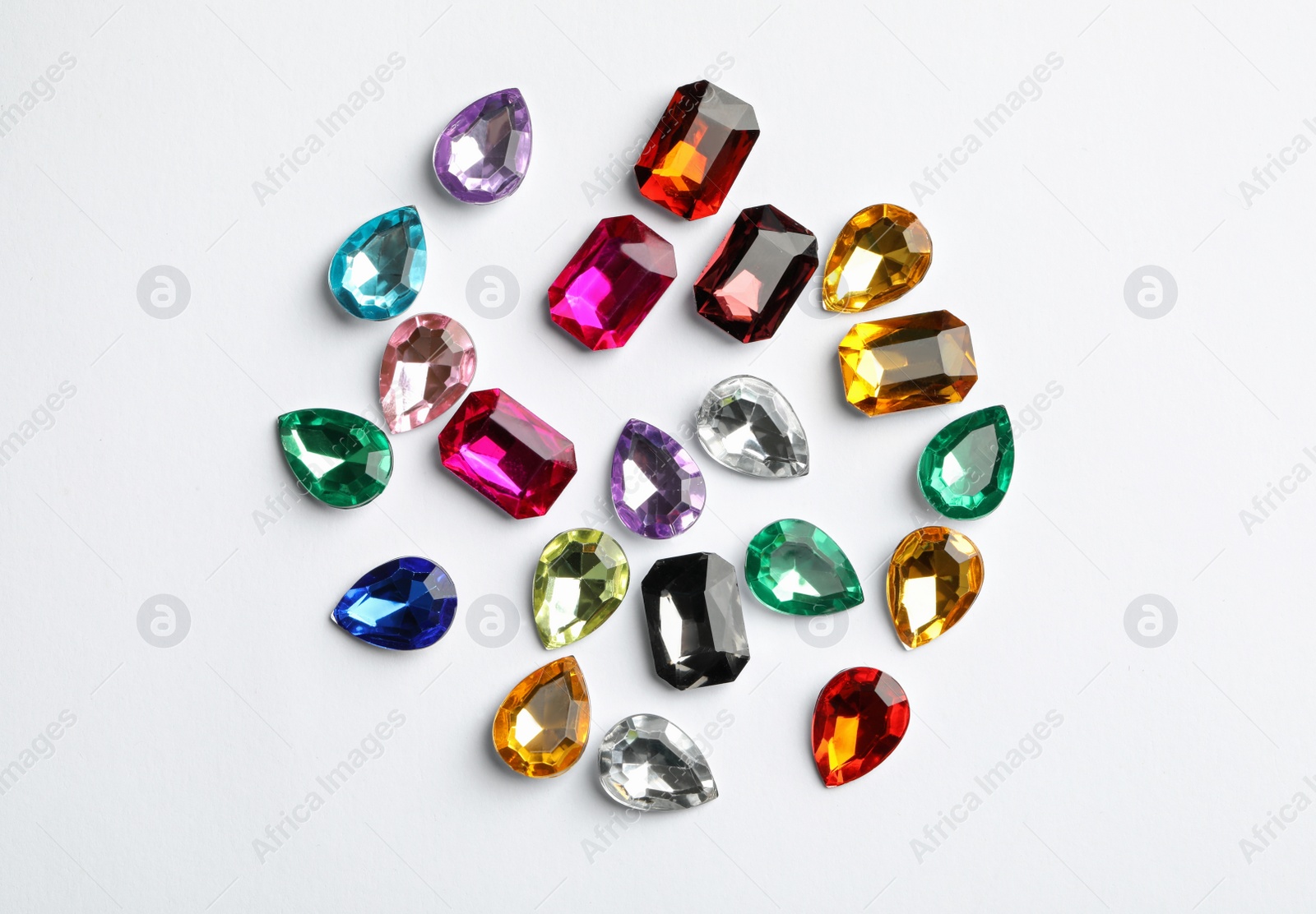 Image of Different beautiful gemstones on white background, top view