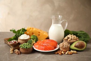 Photo of Different products rich in protein on marble table