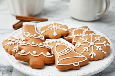 Photo of Plate with tasty homemade Christmas cookies on table, closeup