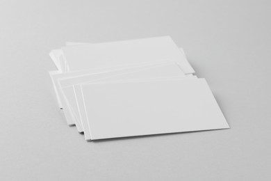 Blank business cards on light grey background. Mockup for design