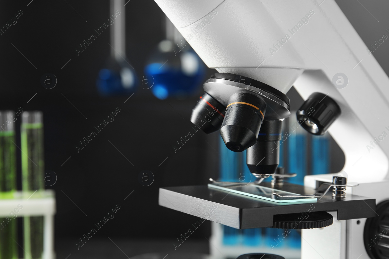 Photo of Modern microscope with different lenses in laboratory, space for text. Medical equipment