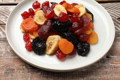 Mix of delicious dried fruits on wooden table, closeup