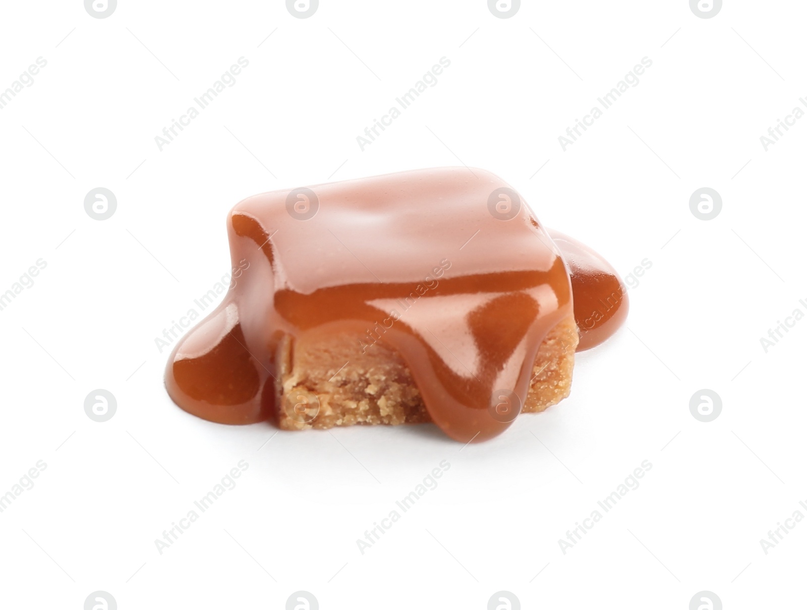 Photo of Delicious candy with caramel sauce on white background