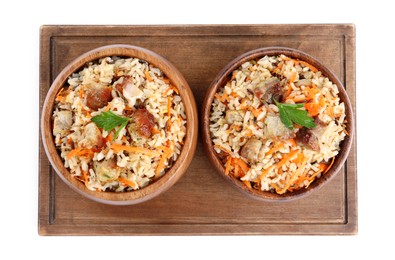 Photo of Delicious pilaf with meat and carrot in bowls isolated on white, top view