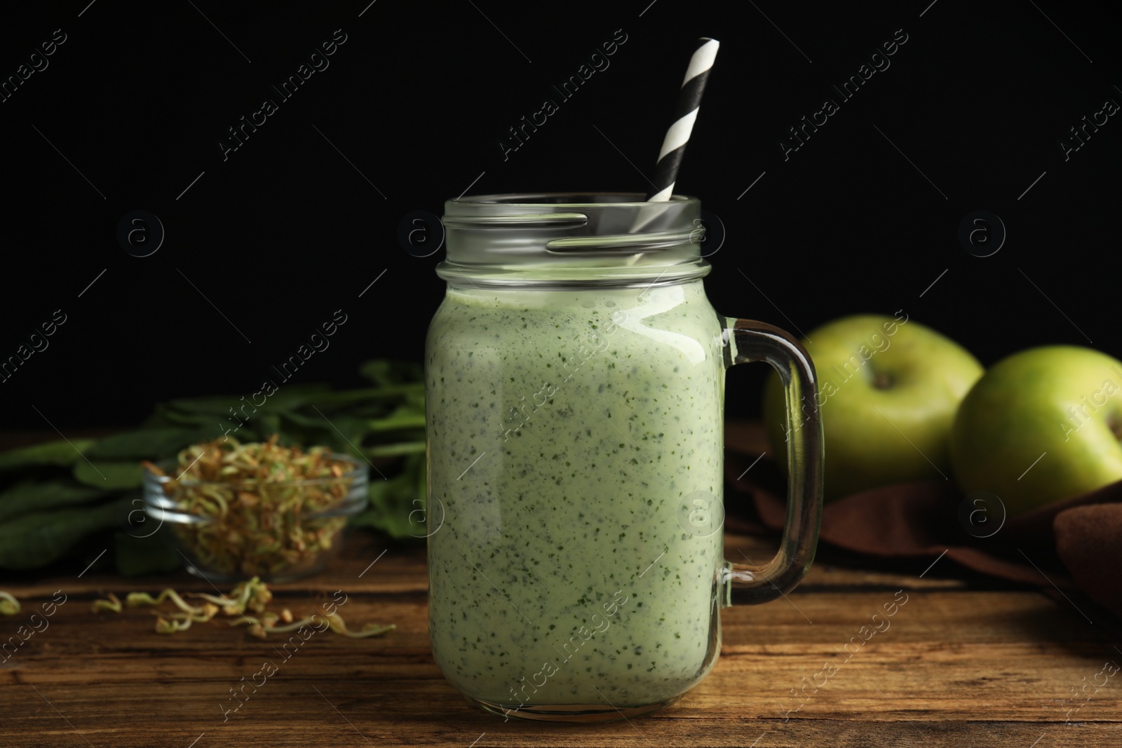 Photo of Tasty green buckwheat smoothie on wooden table