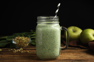 Tasty green buckwheat smoothie on wooden table