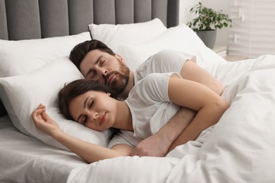 Photo of Lovely couple sleeping together in bed at home