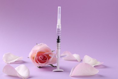 Cosmetology. Medical syringe, rose flower and petals on pink background