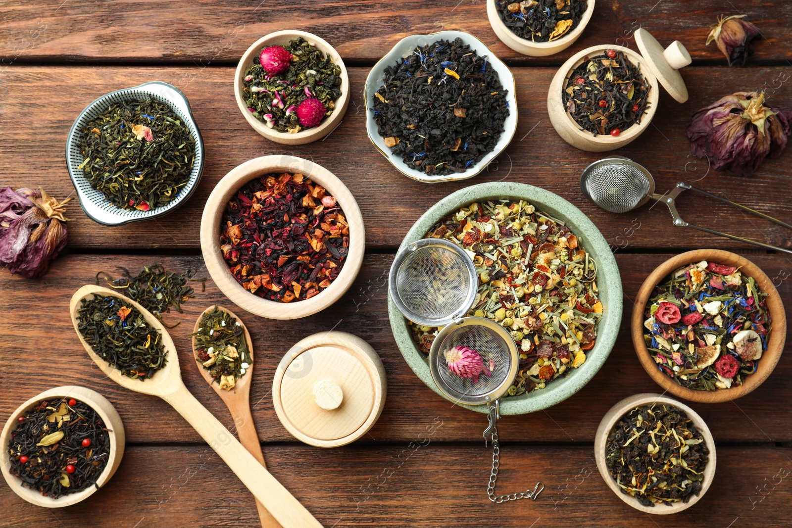 Photo of Many different herbal teas on wooden table, flat lay