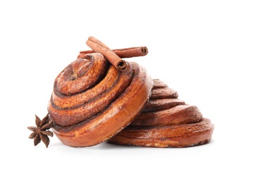 Photo of Freshly baked cinnamon rolls with ingredients on white background