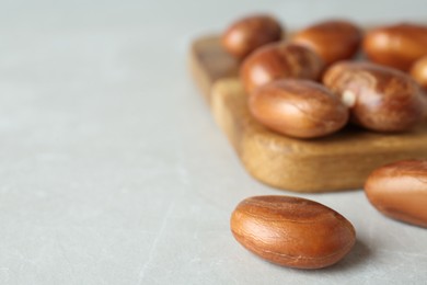 Raw jackfruit seeds on light table, closeup. Space for text