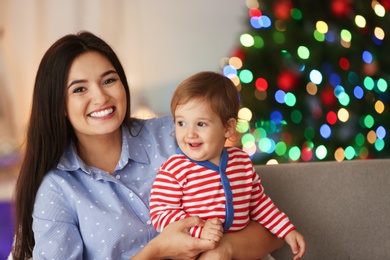 Photo of Mother and her cute baby at home. Christmas celebration