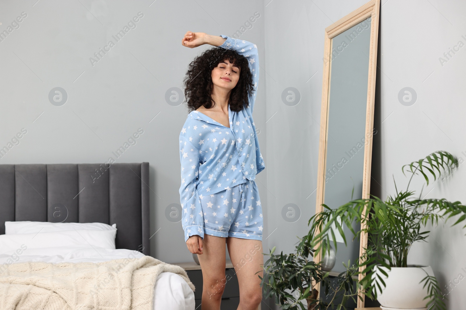 Photo of Beautiful young woman in stylish pyjama at home