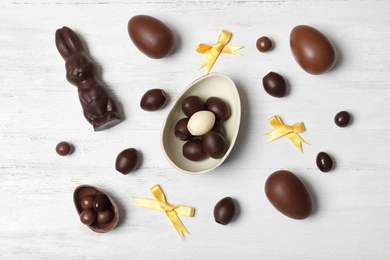 Photo of Flat lay composition with chocolate Easter eggs on wooden background